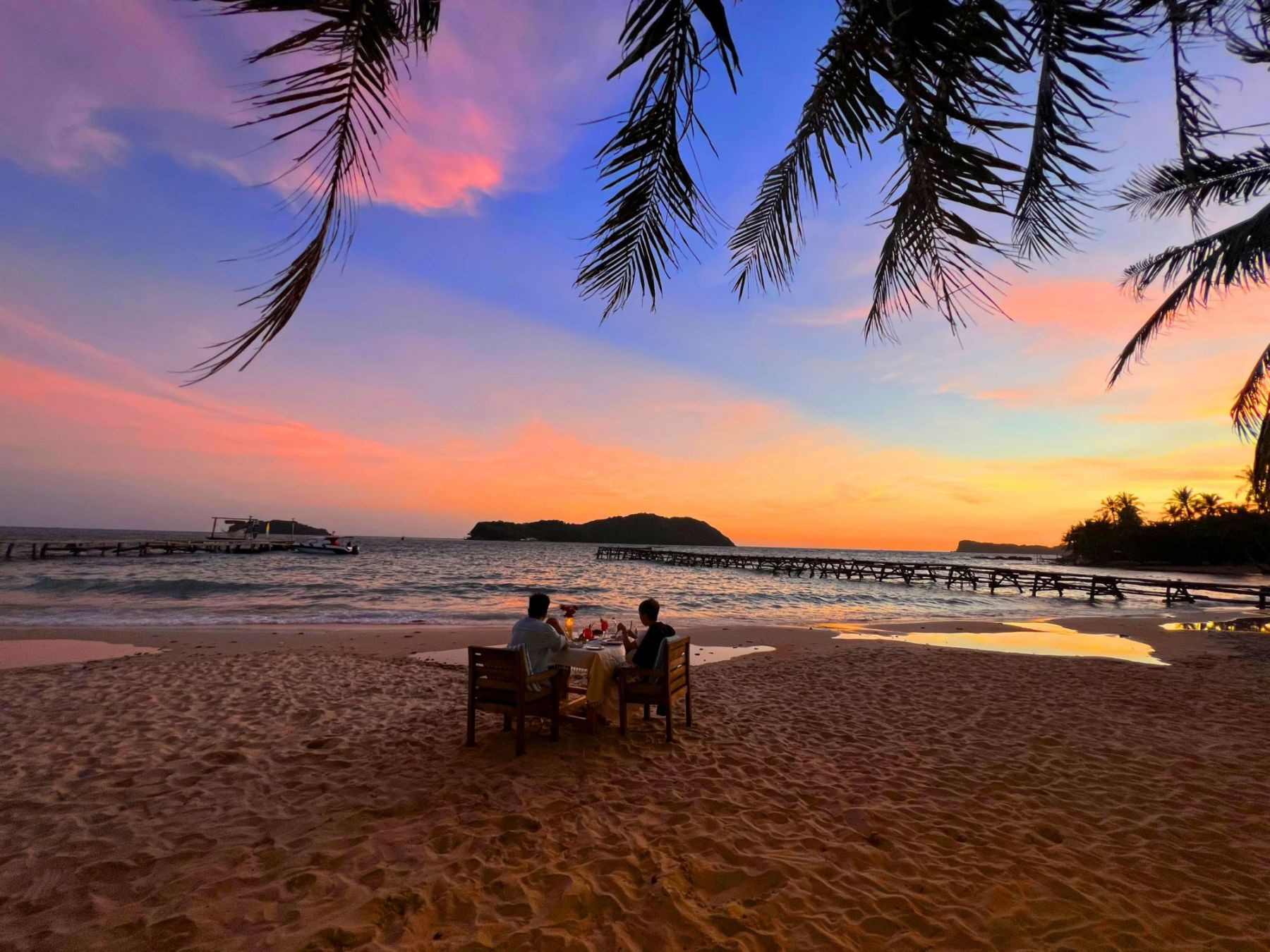Barefoot on the beach and take in the magical sunset.