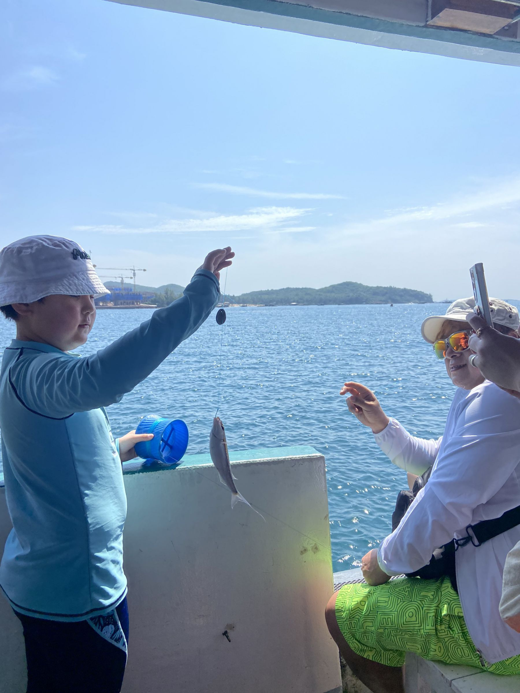 The family is fishing on the boat.